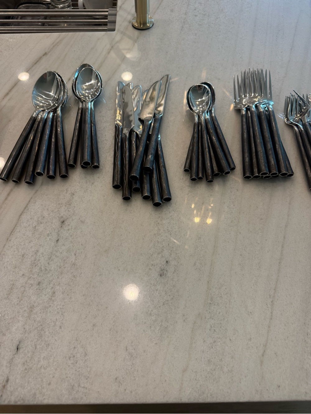 Niwat flatware from Thailand. Eight place settings with four serving utensils.